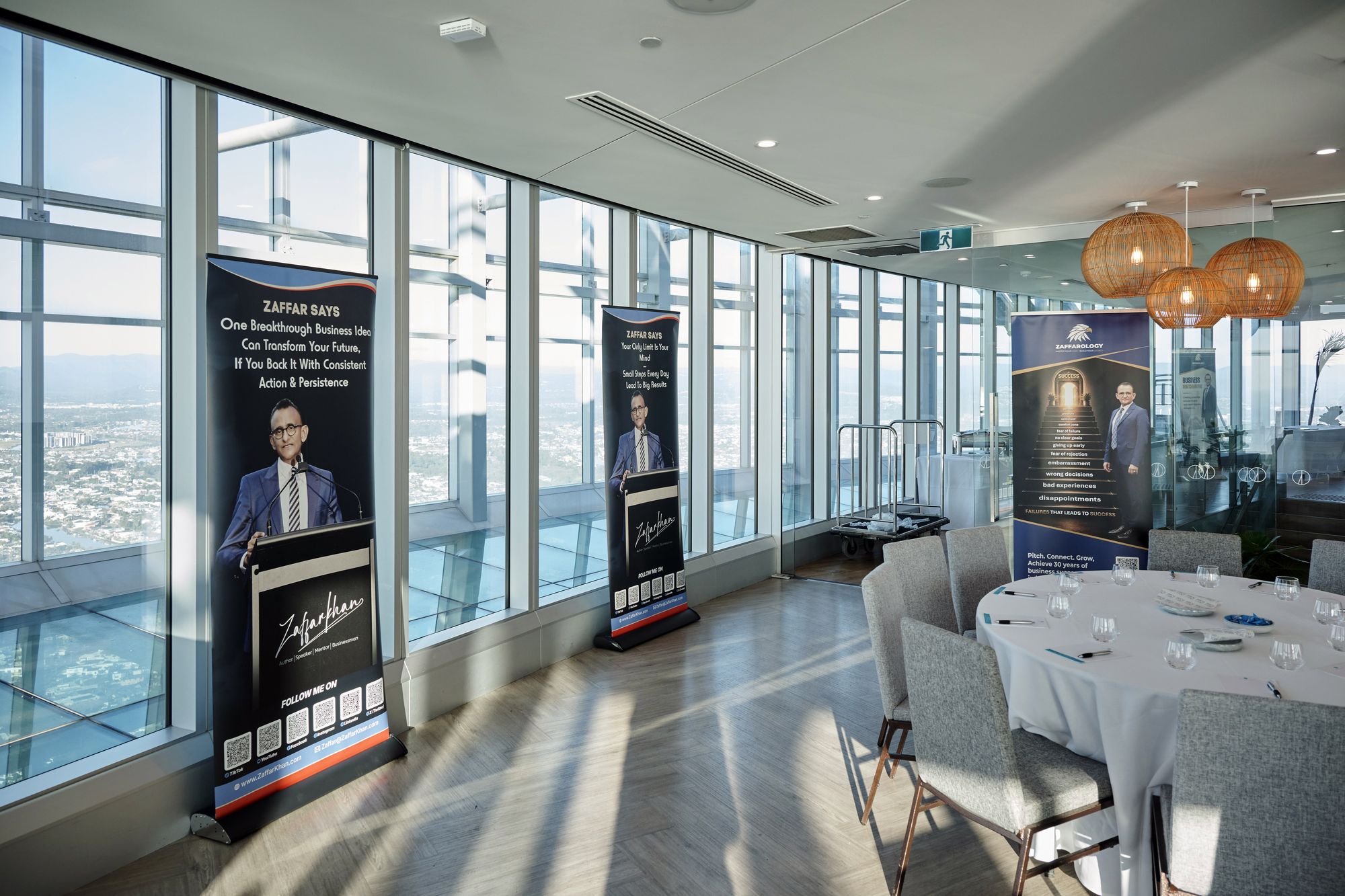 Zaffarology banners lined along the windows beside a set table, city and coastline visible outside