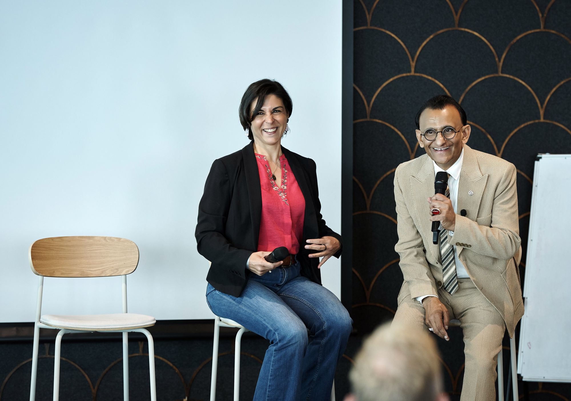 Zaffar Khan interviewing a guest seated beside him on stage